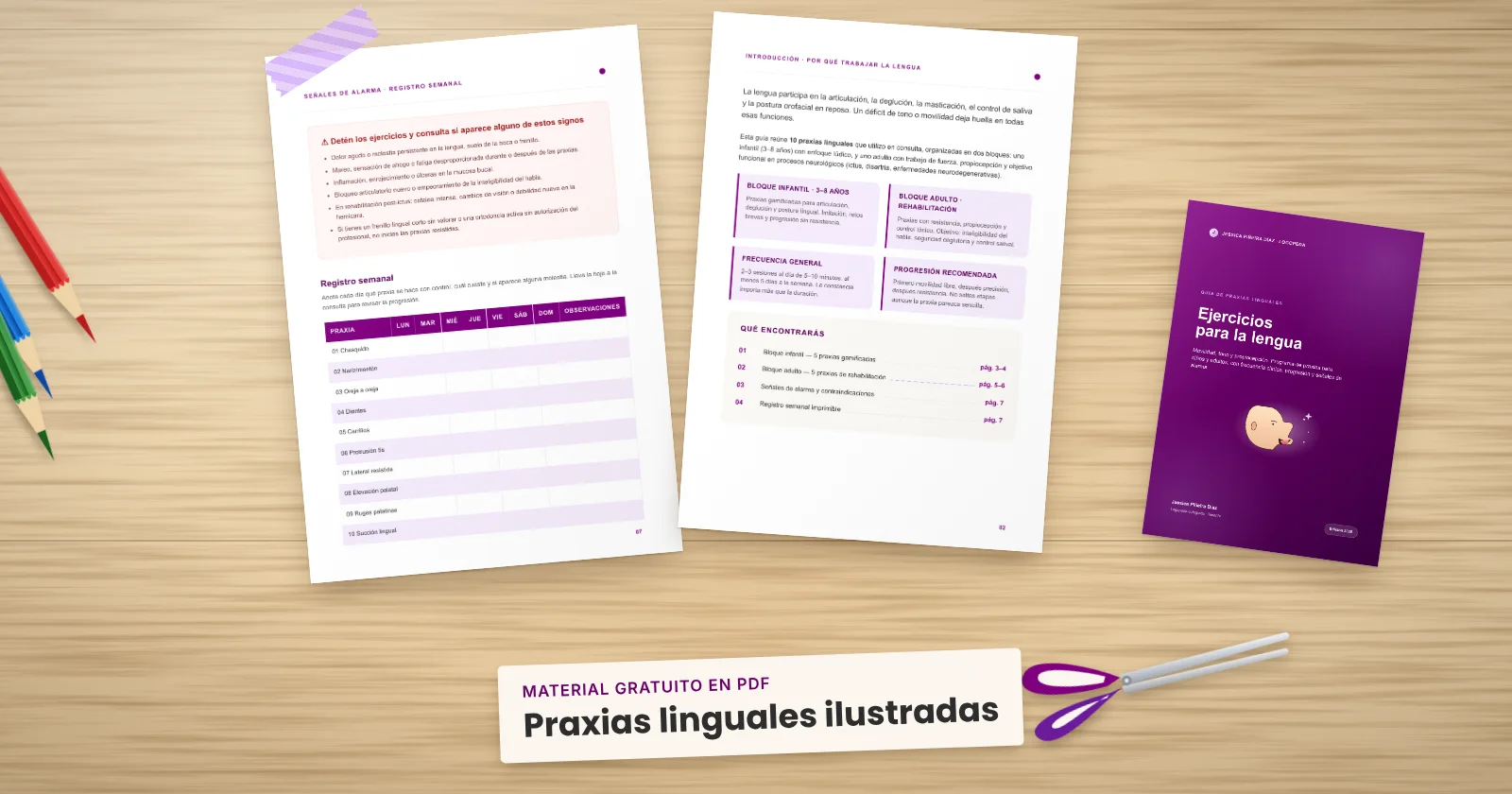 Dos páginas impresas de «Praxias linguales ilustradas» sujetas con cinta washi sobre una mesa de madera, con la portada asomando. Alrededor, una etiqueta de papel con el título, lápices de colores y unas tijeras.
